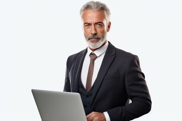 Studio portrait of a mature businessman using a laptop, dressed in a formal suit, exuding confidence and professionalism