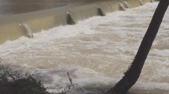 Texas 2025 flood water being released from large flood control dam and running over downstream small dam