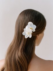 Brunette with Orchids in Half-Up Hairstyle – Soft Neutral Backdrop for Luxury Hair Branding and Instagram Content