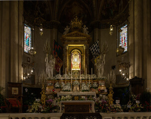 Altar of the Chapel of the Madonna del Conforto with reliquary, Baroque decoration, flowers, and...