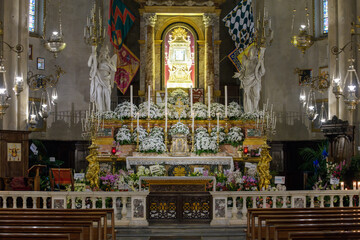 Altar of the Chapel of the Madonna del Conforto with reliquary, Baroque decoration, flowers, and...