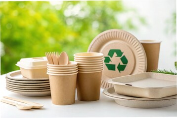 Eco friendly disposable tableware with a green recycling symbol on a plate