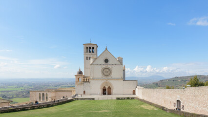 Facade of the Basilica of Saint Francis in Assisi, Italy, featuring a rose window, Gothic portal,...