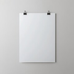 Blank white poster hanging against a neutral wall, ready for your design or creative message with minimalist presentation.