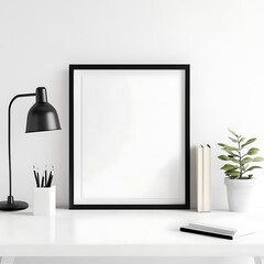 Minimalist desk setup showcases a blank frame, perfect for artwork or posters against a clean, bright, modern backdrop.