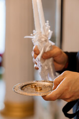 Orthodox Wedding Ceremony Ritual with Candles and Rings. A Priest Holds Lit Candles and a Tray with...