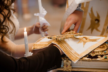 Orthodox Wedding Ceremony: Couple Receiving Blessing with Gold Cross and Illuminated Book, Candles,...