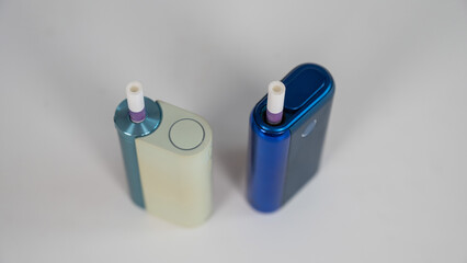 Two electronic cigarettes on a white background. Tobacco heating systems.