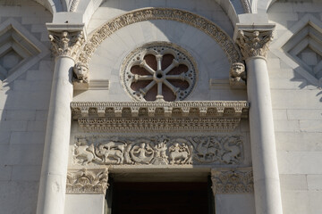 Main portal of San Michele in Foro, Lucca, Italy, with rose window, sculpted archivolt, column...