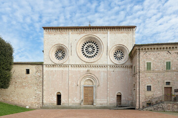 Romanesque facade of the Abbey of Saint Peter in Assisi, Umbria, Italy, with central rose window,...
