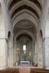 Interior of the Abbey of Saint Peter in Assisi, Umbria, Italy, with Romanesque stone arches,...