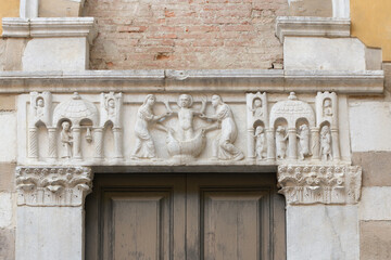 Marble architrave with baptismal scene by Biduino, Romanesque portal of San Salvatore Church,...
