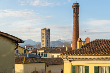 Panoramic view of Lucca with bell tower of San Frediano and a tall red chimney, Tuscan architecture...