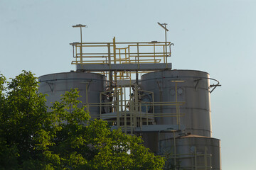 There is an exceptionally tall building standing prominently, which features a staircase elegantly positioned at its very top