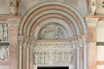 Romanesque marble lunette depicting the martyrdom of Saint Regulus above a portal of San Martino...