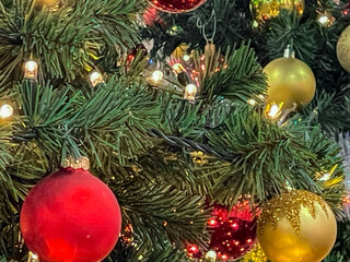 Christmas tree decoration with golden and red balls, illuminated lights and garland, Christmas card, greetings, fullframe, close up