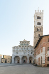San Martino Cathedral and bell tower in Lucca, Italy, Romanesque facade with sculpted arches and...