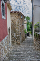 Narrow cobblestone street in historic mediterranean hilltop town Motovun, Croatia.