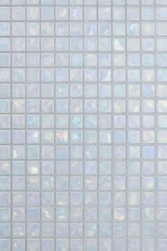 Elegant iridescent texture of glass mosaic tiles with soft pastel reflections. Elegant, minimalistic and laconic background for creative projects and digital art.