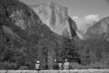 Yosemite National Park, CA USA - June 24, 2022: Black and white image showing the group of people watching Yosemite Valley from Tunnel view