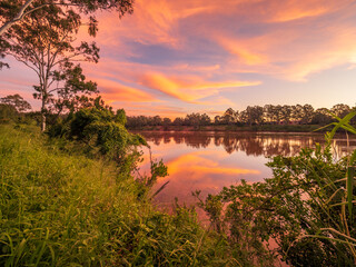Beautiful Sunset Over The River with Cloud Reflections