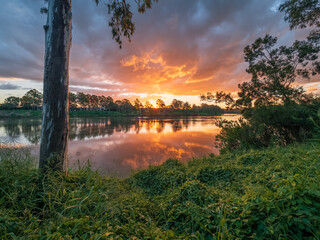 Beautiful Sunset Over The River with Cloud Reflections