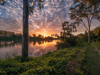 Beautiful Sunset Over The River with Cloud Reflections