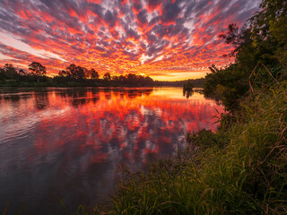 Beautiful Sunset Over The River with Cloud Reflections