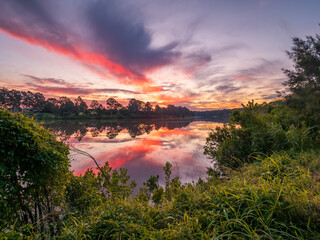 Beautiful Sunset Over The River with Cloud Reflections