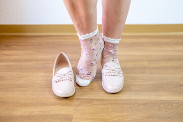 Female legs close up, Comfortable footwear, Shoes paired with stylish socks, personal care, between...