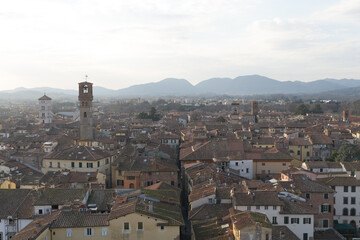 View from Torre delle Ore of Via Fillungo in Lucca, Italy, showing rooftops, medieval towers and...