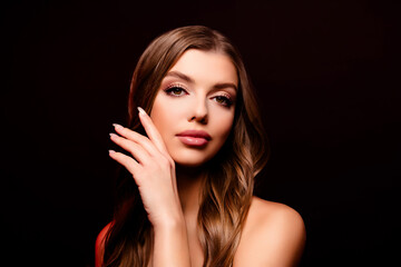 Fototapeta premium Portrait of attractive tender young lady model touching perfect silky smooth skin isolated black color background