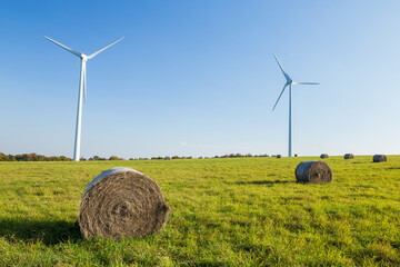 Straw bales in f ront of windmills in Czech Republic