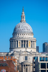 The majestic dome of St. Paul's Cathedral rises against a vibrant blue sky, showcasing its architectural grandeur in the heart of London. It stands as a symbol of historical significance.