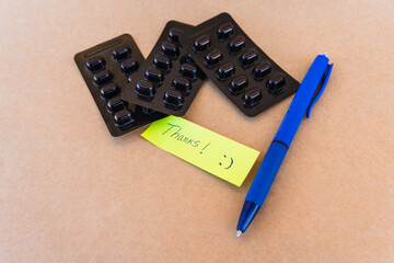 Thank you note that says thank you handwritten with blue pen with a background of an oximeter and...