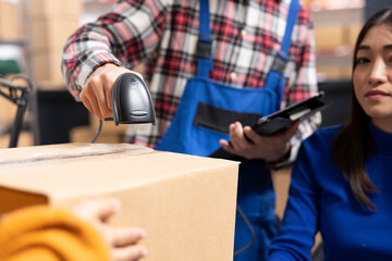 Startup employees processing orders with bar codes and invoices in a supply room. Preparing...