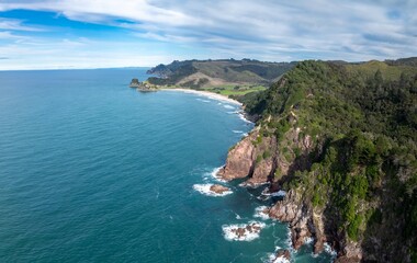 Aerial view of the coastline in Whiritoa, Coromandel Peninsula, New Zealand. The turquoise ocean...