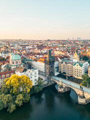 Stunning aerial view captures Charles Bridge and the Old Town Bridge Tower at sunrise, surrounded...