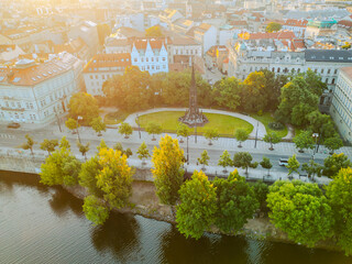 Aerial view of the Park of the National Awakening in Prague, featuring Kranner's Fountain surrounded by greenery along the Vltava River in the heart of the city.
