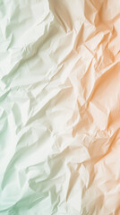 Crumpled gradient paper background transitioning from light green to light orange