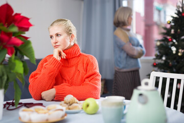 Portrait of an offended adult daughter at her elderly mother, who quarreled with her before...