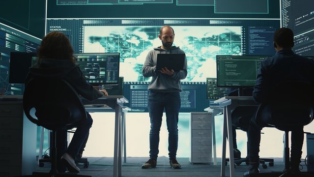 Hackers group using ransomware and phishing tactics to compromise computer networks and gather intelligence for national security and protection during cyberwarfare. Governmental spyware. Camera B.