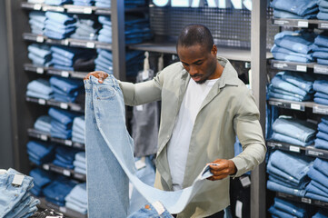 Customer choosing jeans in clothing store