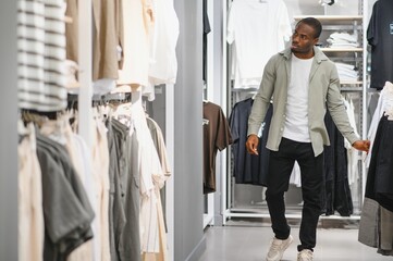 Customer choosing clothes in fashion store