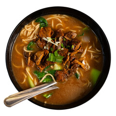 Deep clay bowl with noodle soup and boiled beef pieces. Traditional Chinese cuisine dish is decorated with greens and celery. Isolated over white background