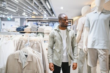 Customer choosing clothes in fashion store