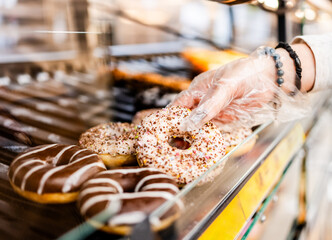 Girl Is Choosing Donuts At Supermarket