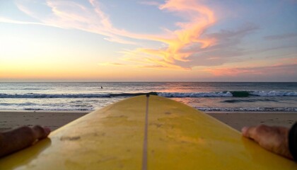 Surfing at sunset offers a peaceful ocean view with a yellow surfboard on a sandy beach for watersports enthusiasts.