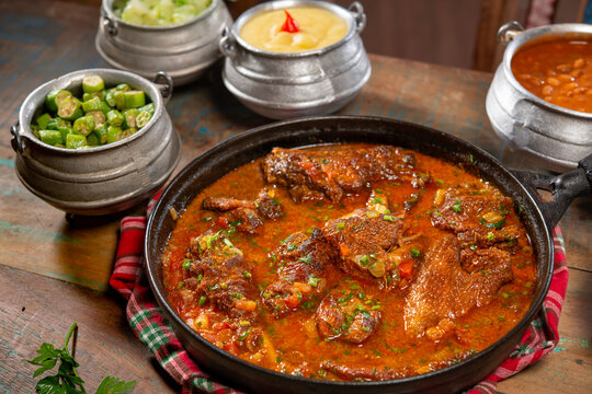tipical brazilian recipe with farm chicken, gravy, rice and okra ( galinha caipira ).