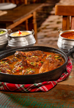 tipical brazilian recipe with farm chicken, gravy, rice and okra ( galinha caipira ).